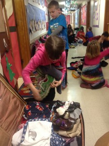 Sorting and packing warm clothing donations.