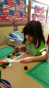 Measuring leprechaun height with cubes and paper clips.